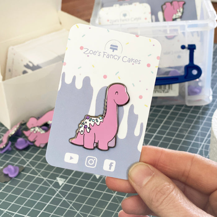 Zoe’s Fancy Cakes Dino pin - Pale Pink colour